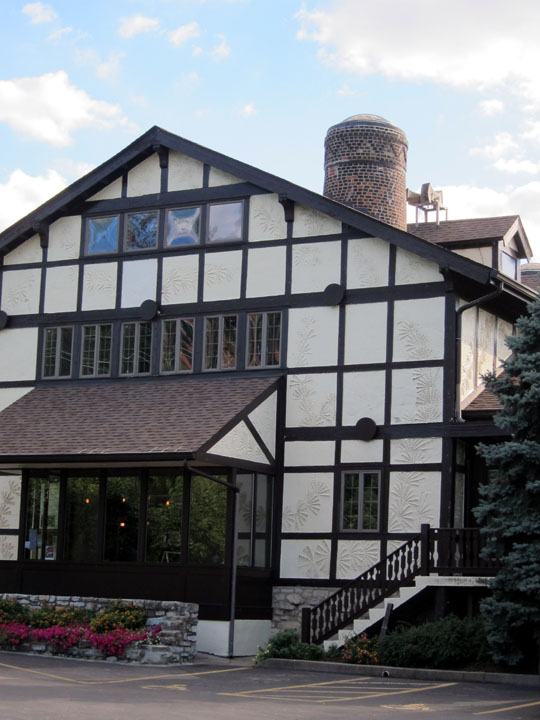 Exterior of the former Rookwood factory. The kiln stack is visible rising from the roof line.
