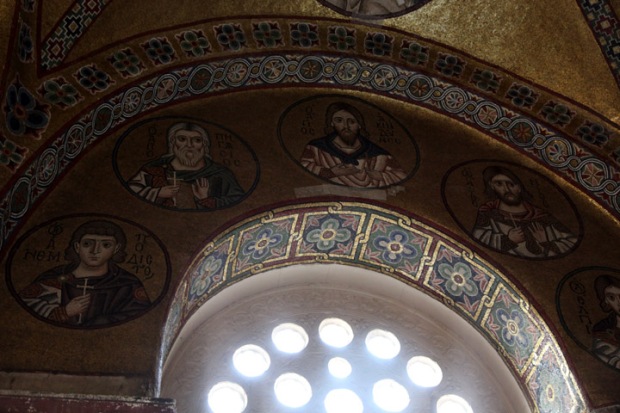 Window frames in mosaic roundels of saints.