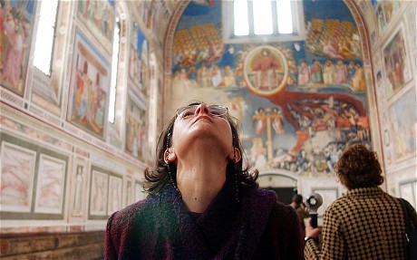 A woman (i.e. not me) looks at the Giotto frescoes at the Scrovegni chapel, in Padua, northern Italy  Photo: AP via The Telegaph)